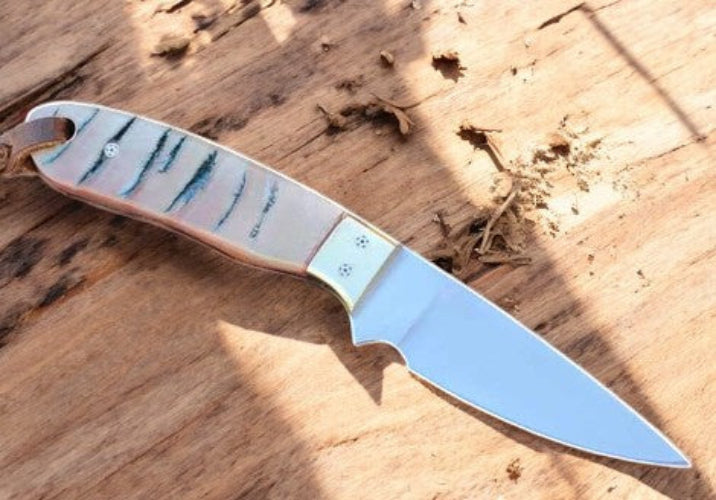 Knife with a decorative handle on a wooden surface
