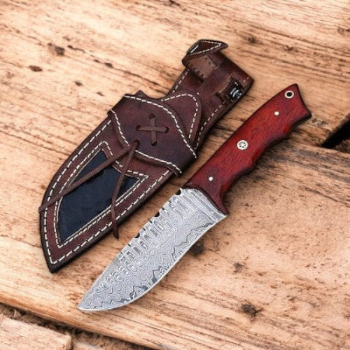 Knife with wooden handle and leather sheath on a wooden surface