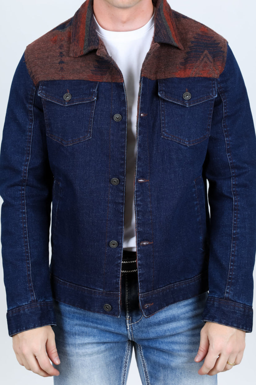 Man wearing a blue denim jacket with brown collar against a white background