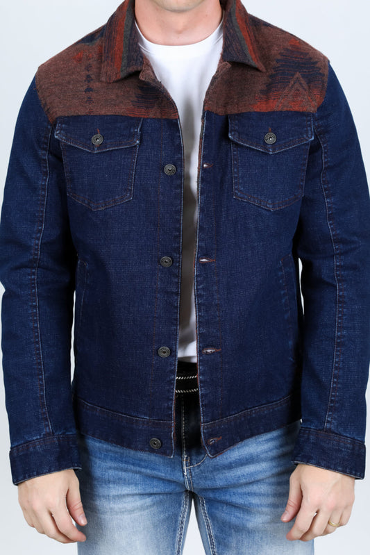 Man wearing a blue denim jacket with brown collar against a white background