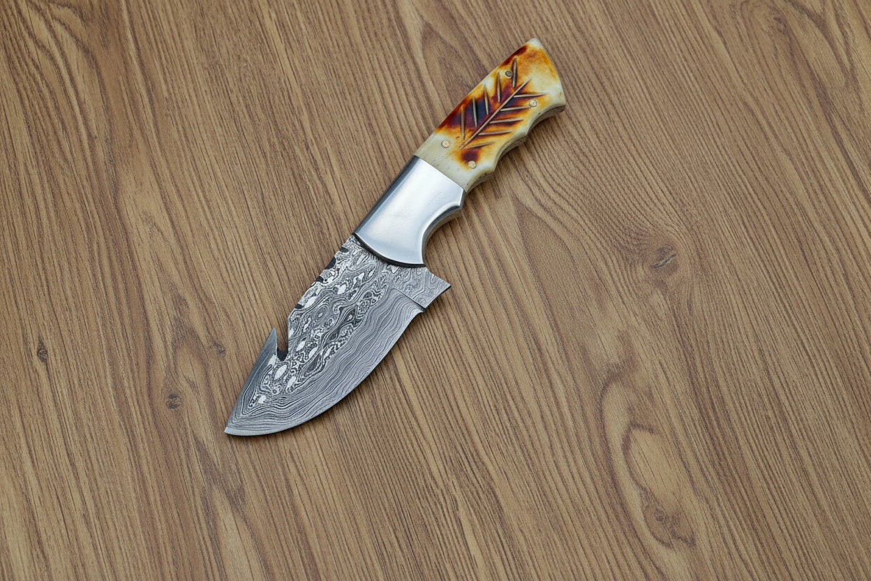 Decorative knife with a detailed blade and tortoiseshell handle next to a ruler on a light gray background