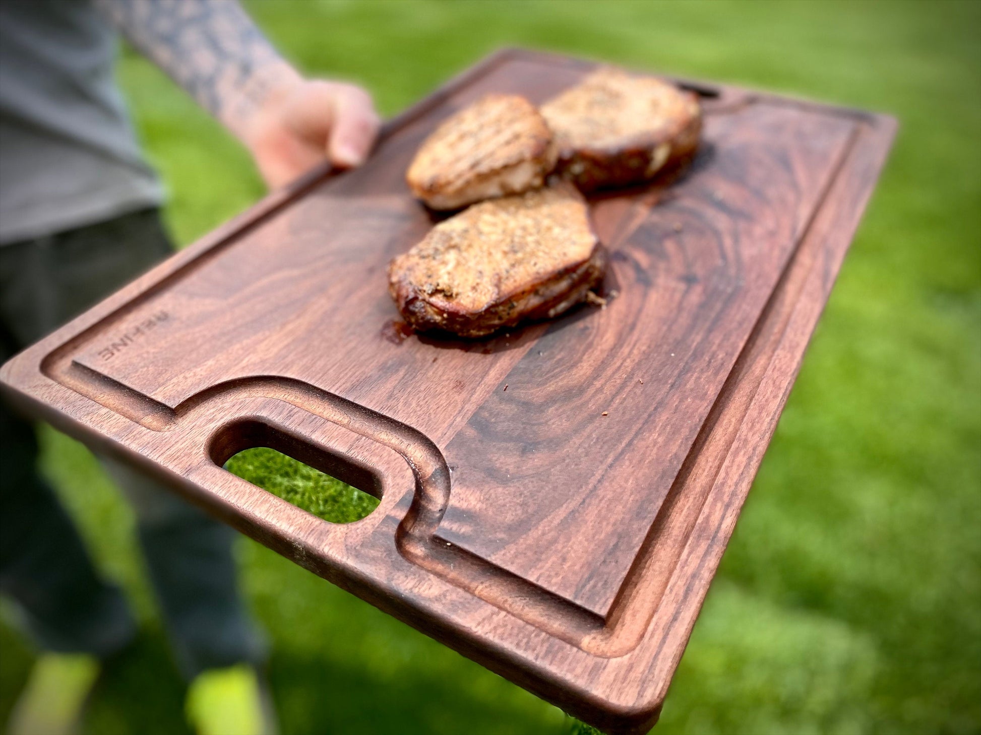 Wooden cutting board with baked goods on a grassy background