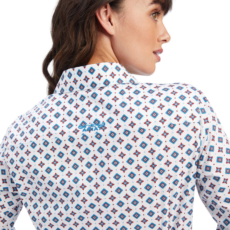 Woman wearing a patterned shirt with a white background
