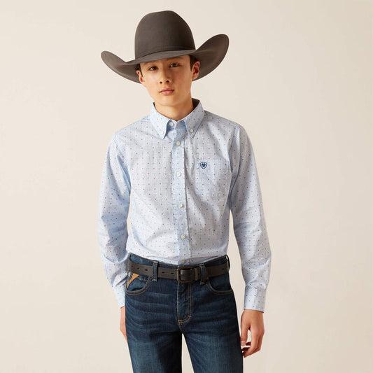 Person wearing a light blue patterned shirt, dark jeans, and a brown cowboy hat on a beige background