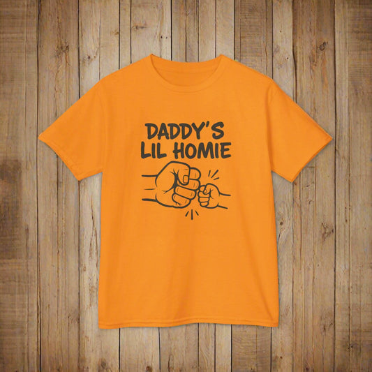 Orange t-shirt with 'Daddy's Lil Homie' text and graphic on a white background