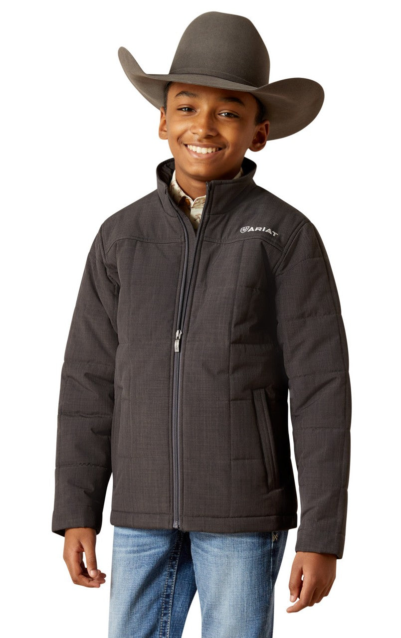 Child wearing a dark jacket with a brand logo, blue jeans, and a cowboy hat on a white background