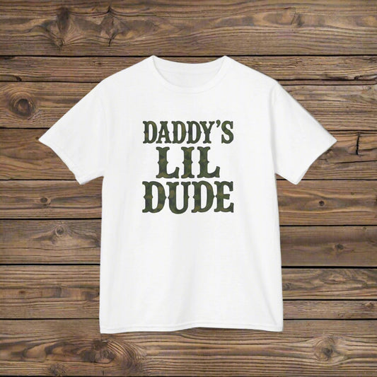 White t-shirt with 'DADDY'S LIL DUDE' text in green on a white background