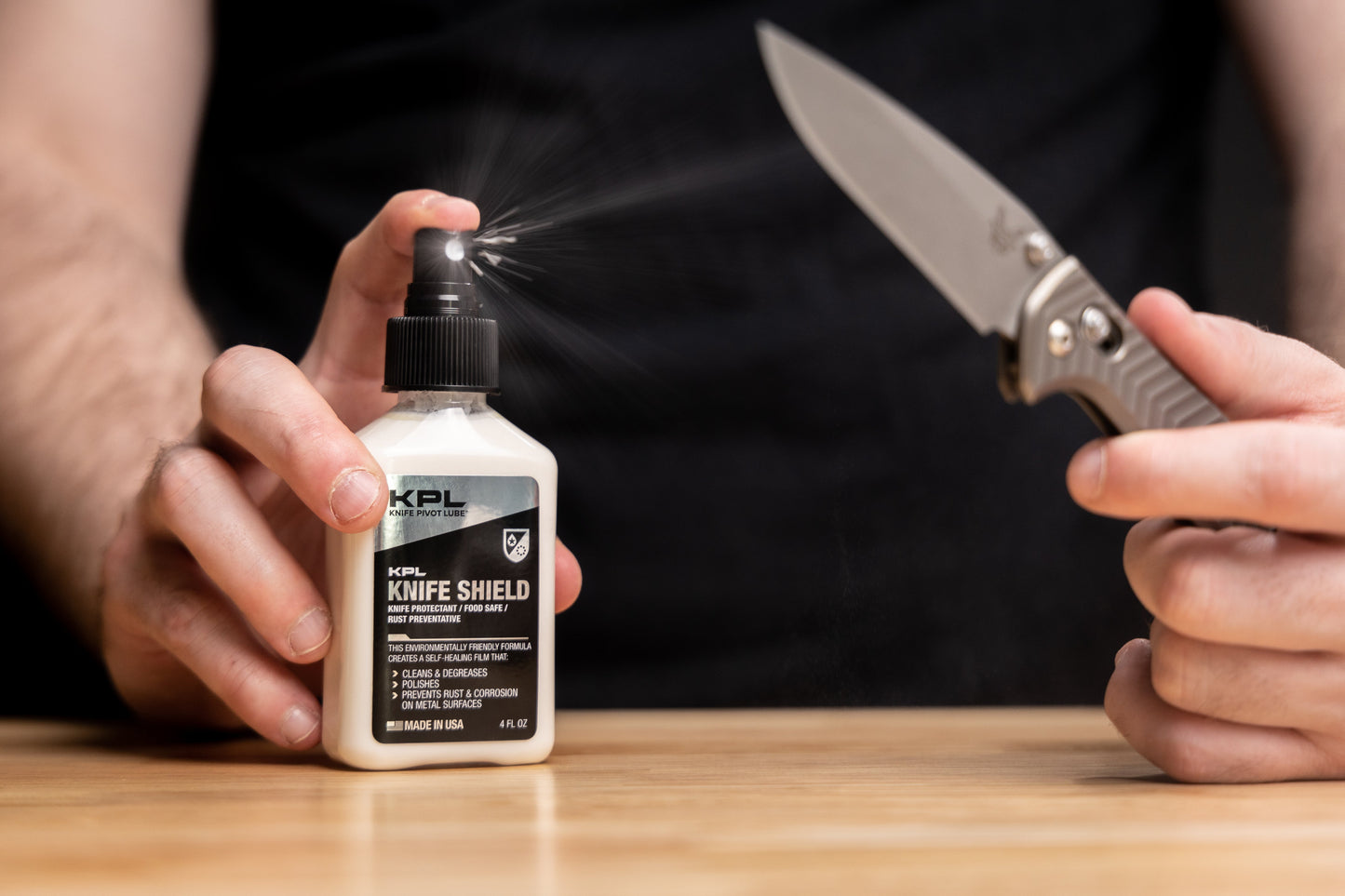 Person using KPL Knife Shield on a knife with a dark background