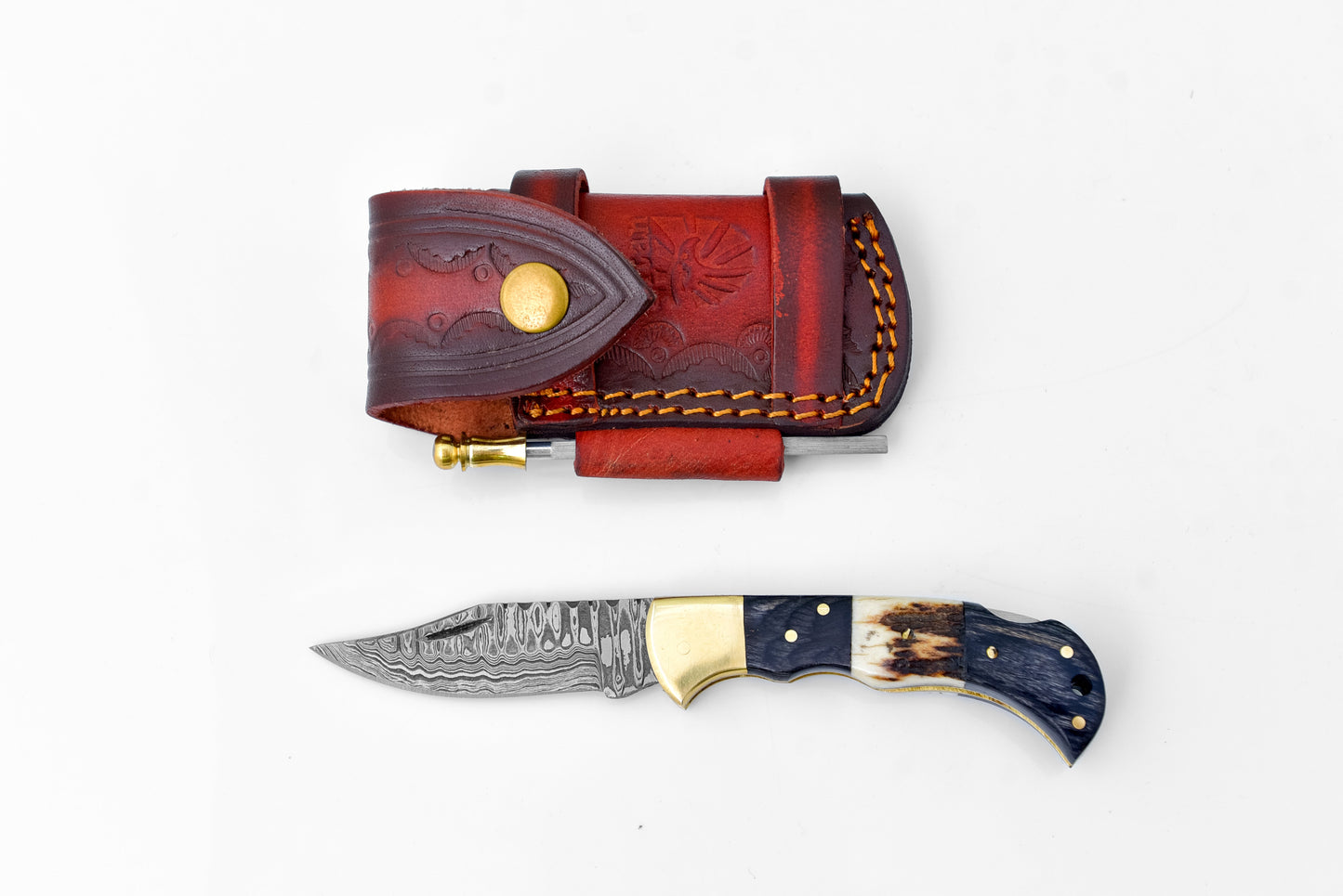 Decorative knife with a leather sheath on a white background