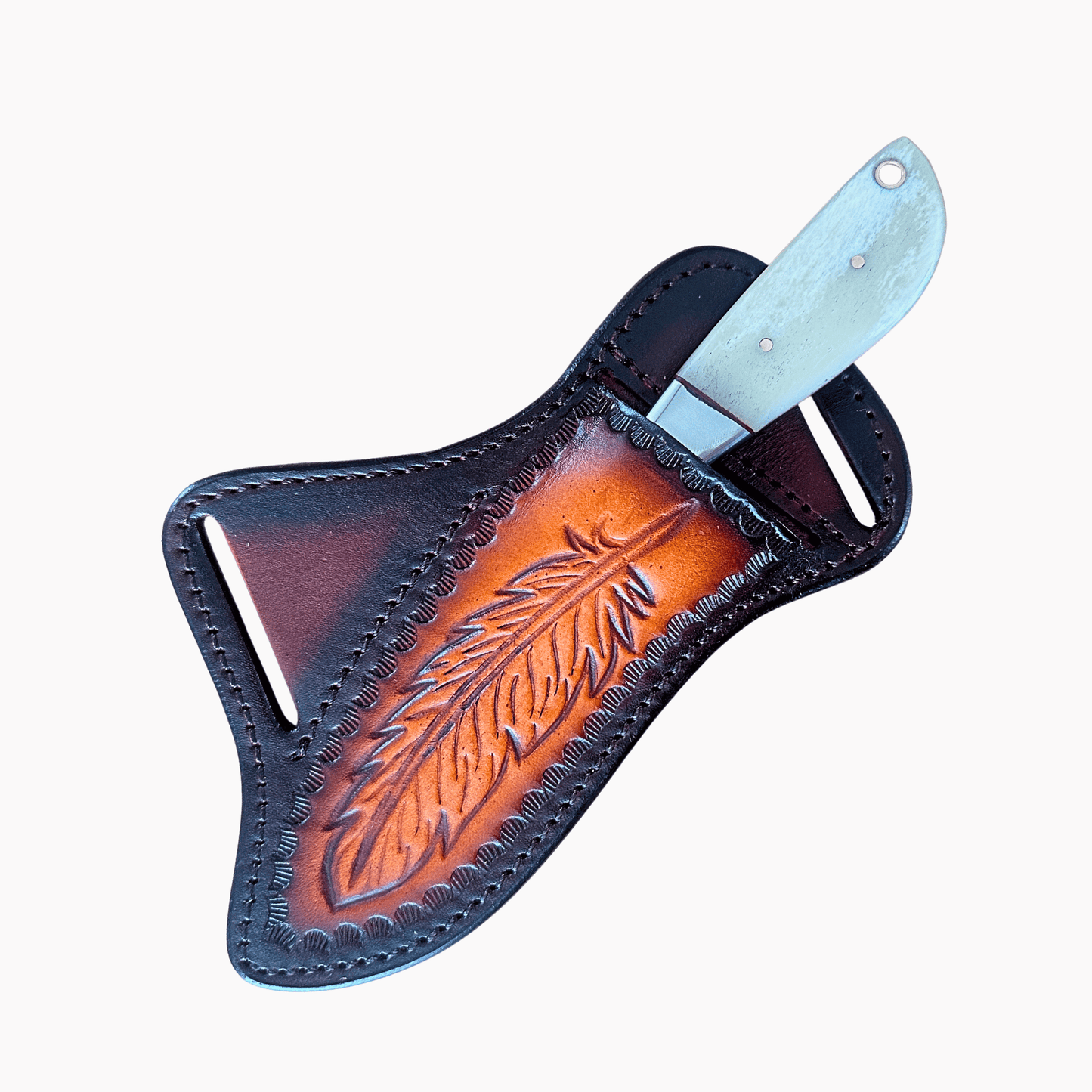 A hand-tooled leather sheath with an engraved feather design, holding a knife with a white bone blade, set against a plain light gray background.