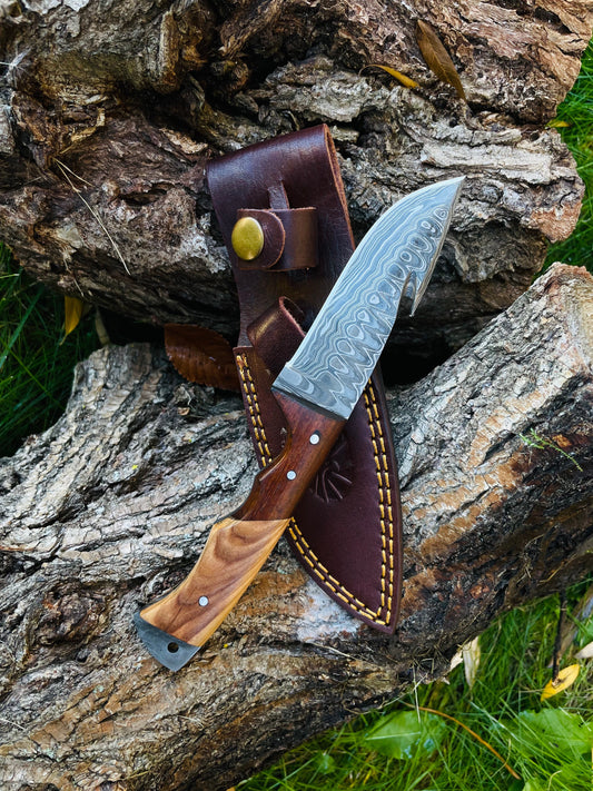 Knife with wooden handle and leather sheath on a wooden surface