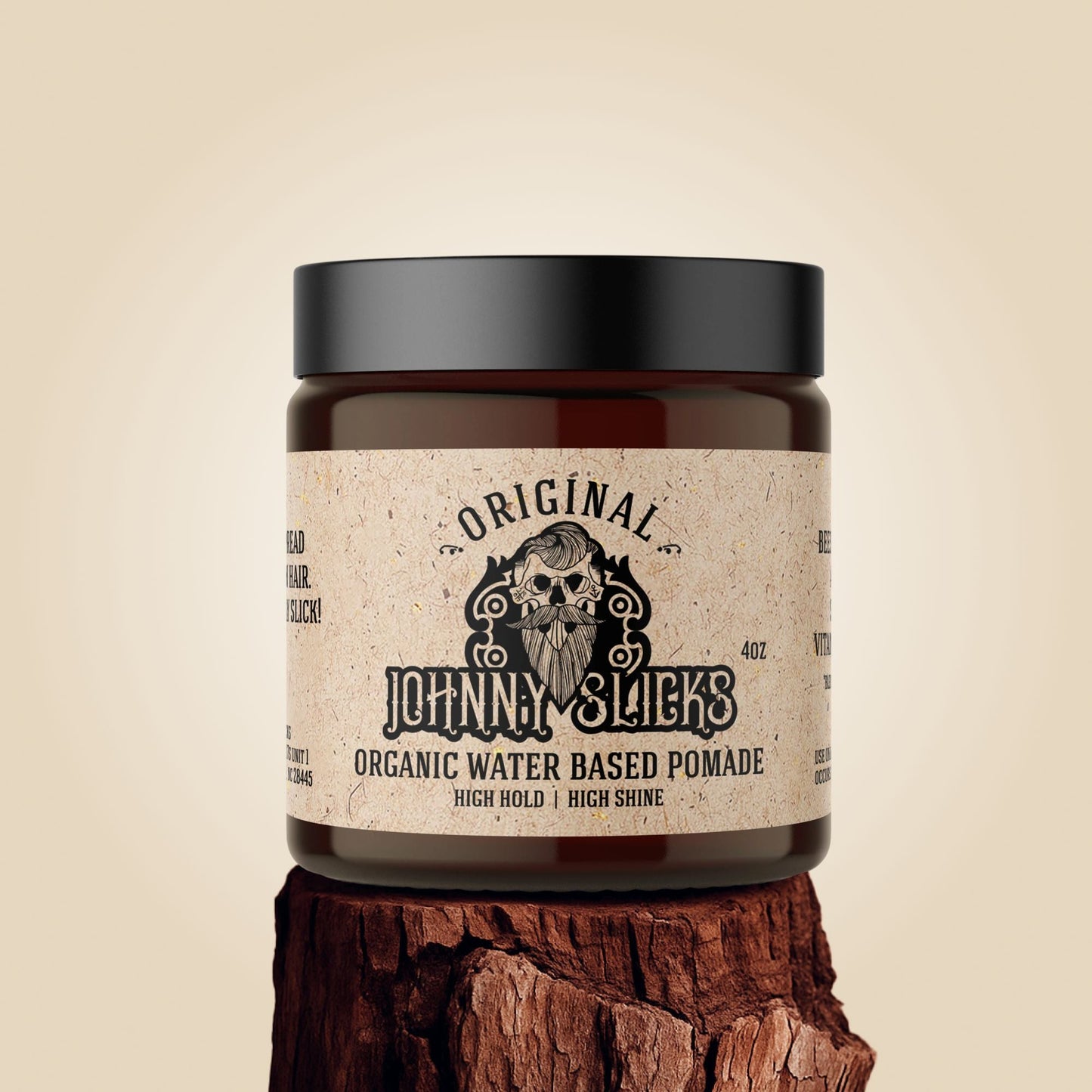 Jar of Johnny Slicks organic water-based pomade on a wooden block with a beige background
