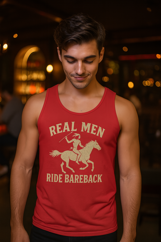 Man wearing a red tank top with a graphic and Real Men Ride Bareback text in a dimly lit setting