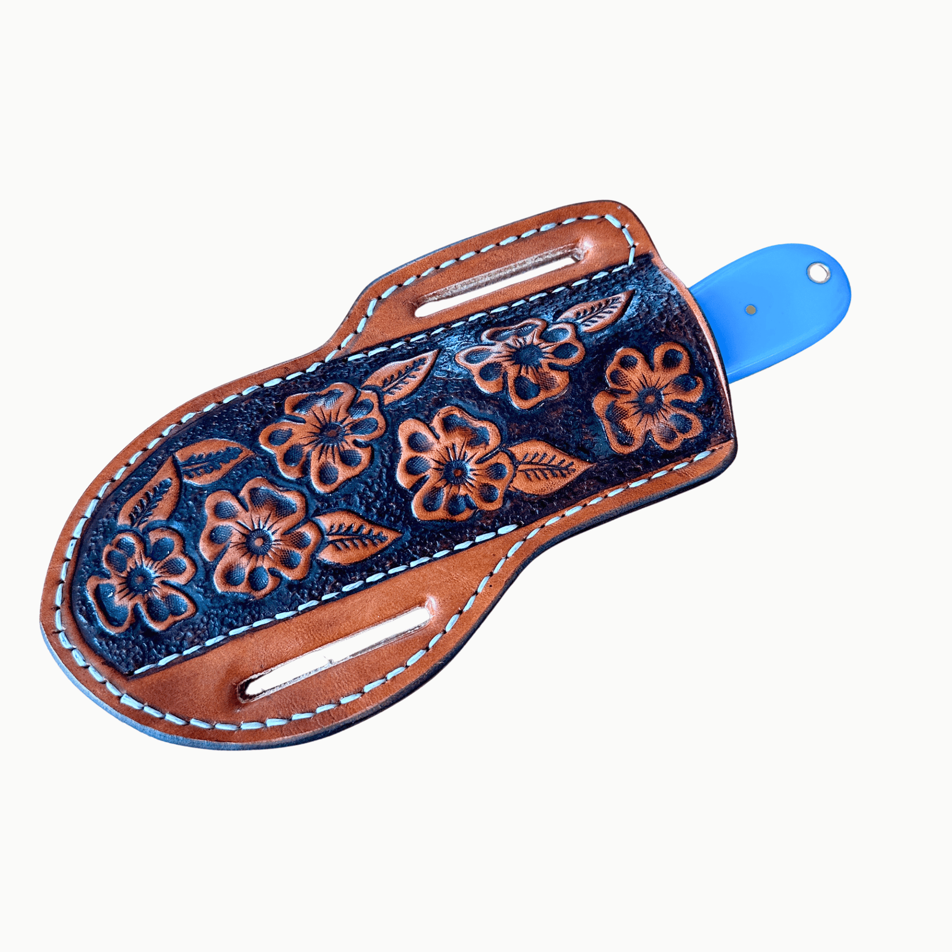 A hand-tooled leather sheath with floral designs, featuring a dark blue center, brown leather edges, white stitching, and the Blue Bonnet hunting knife, shown on a plain light background.