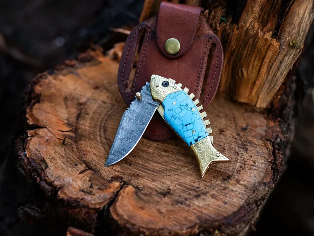 Fish-shaped pocket knife with leather sheath on a wooden surface