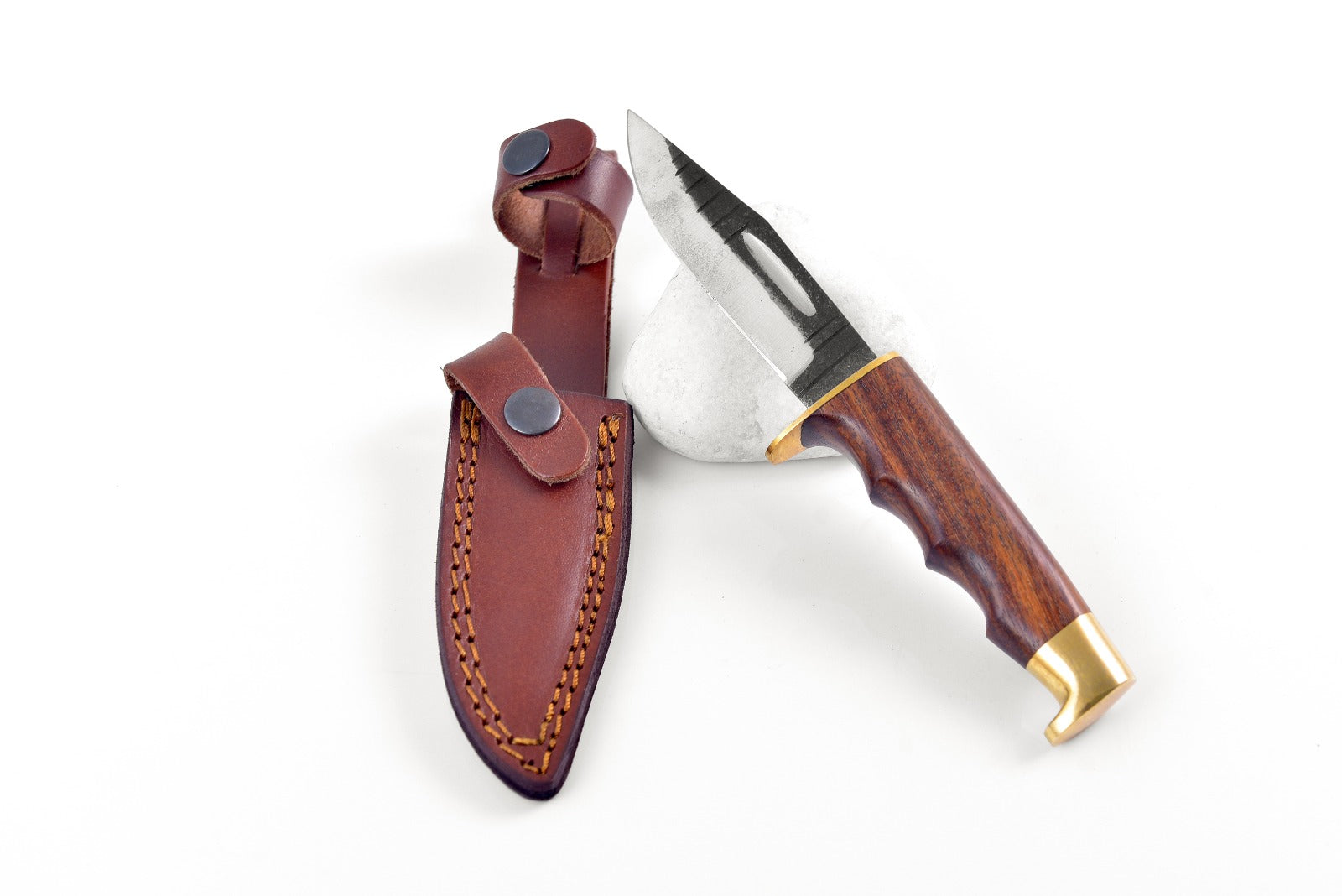 Knife with wooden handle and leather sheath on a white background