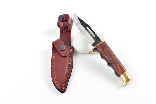 Knife with wooden handle and leather sheath on a white background