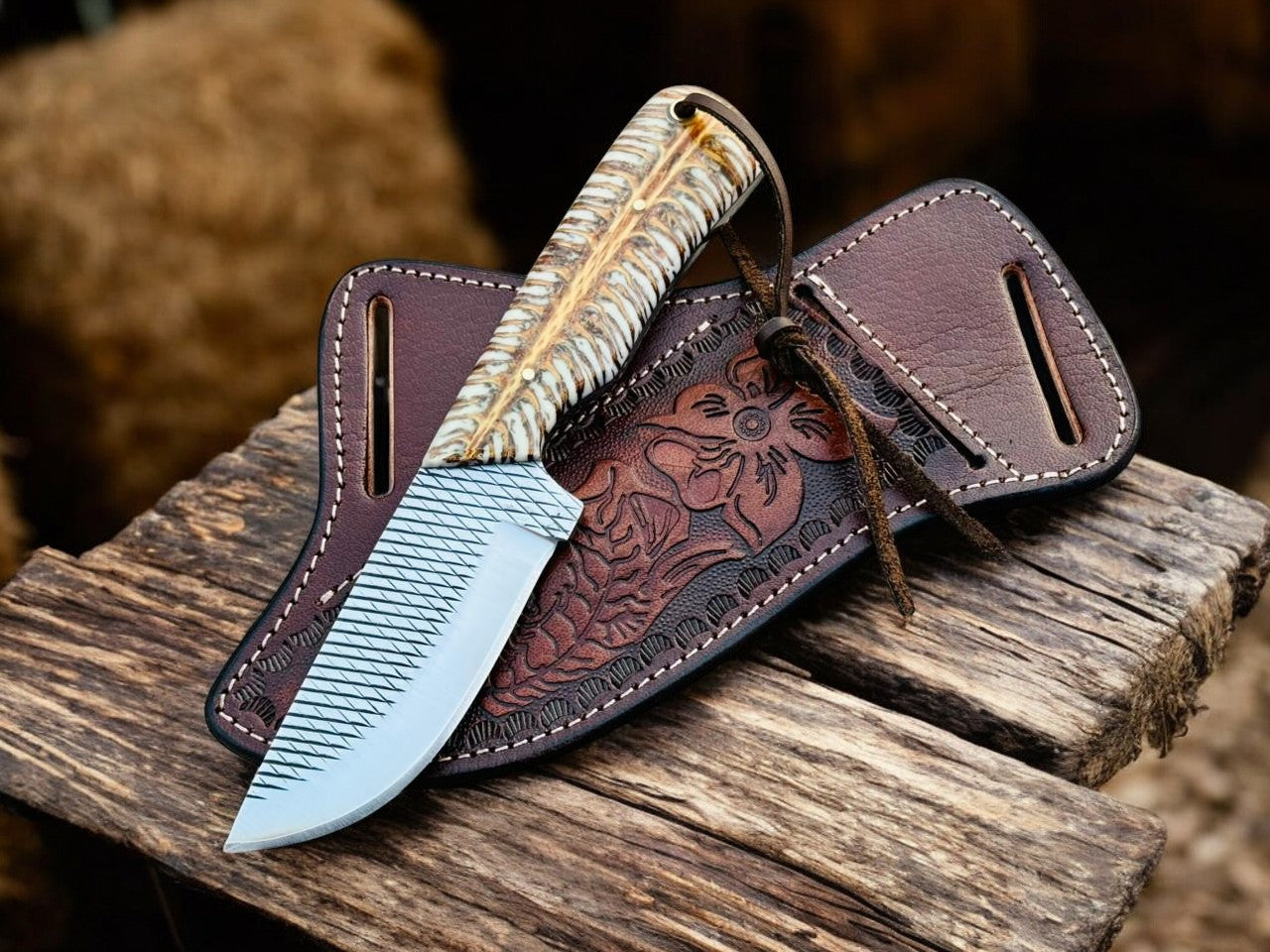 Decorative knife with leather sheath on a wooden surface