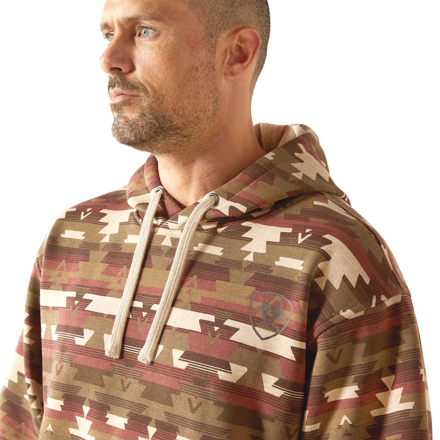 Man wearing a Aztec patterned Ariat hoodie on a white background featuring tribal print and lined sweatshirt 