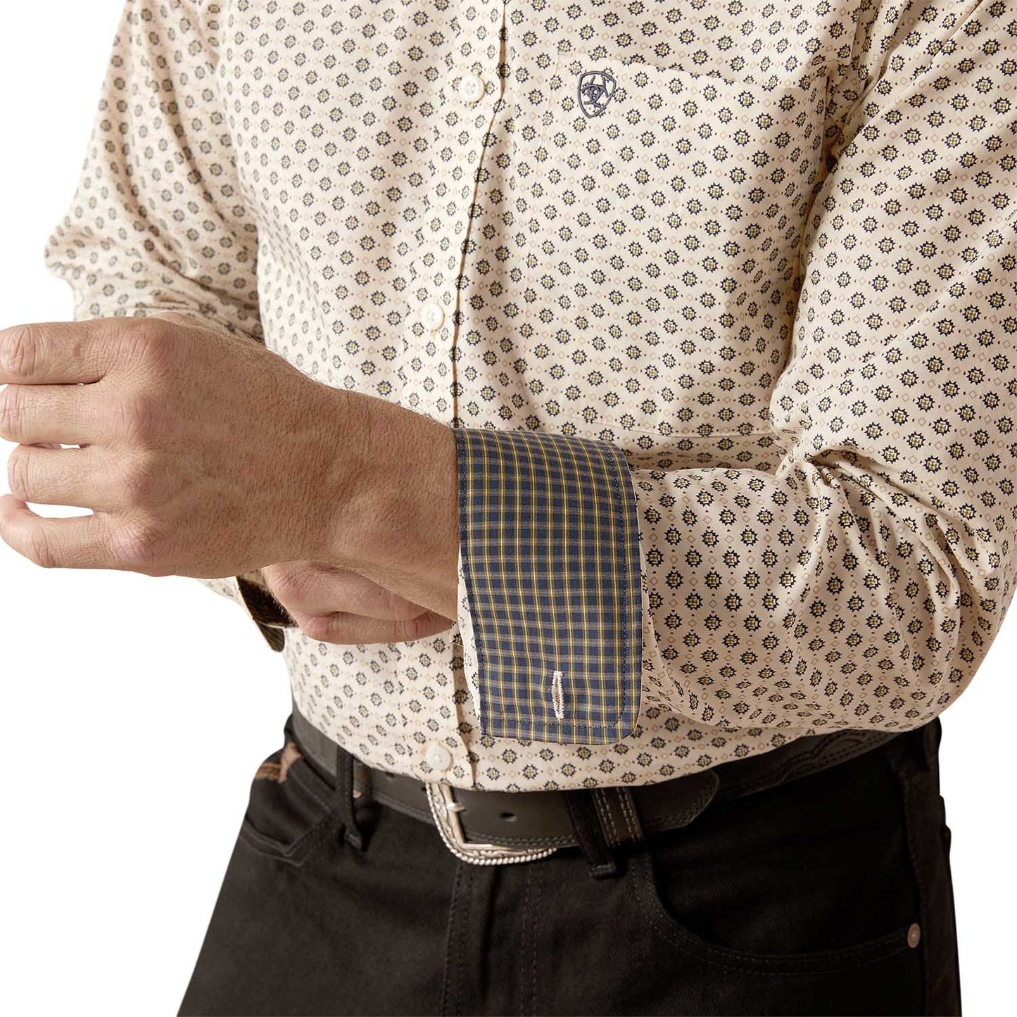 Close-up of a person wearing a patterned shirt with rolled-up sleeves on a white background