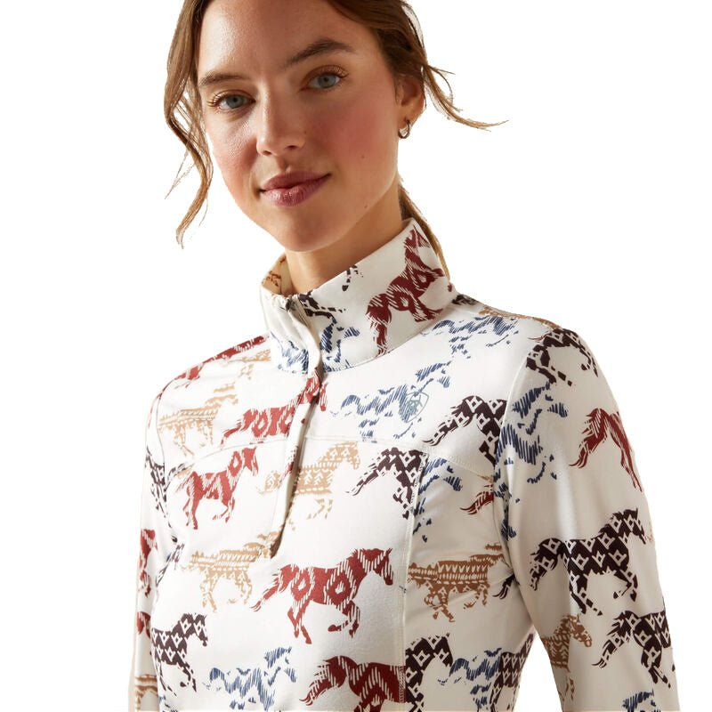 Woman wearing a white shirt with horse pattern on a white background