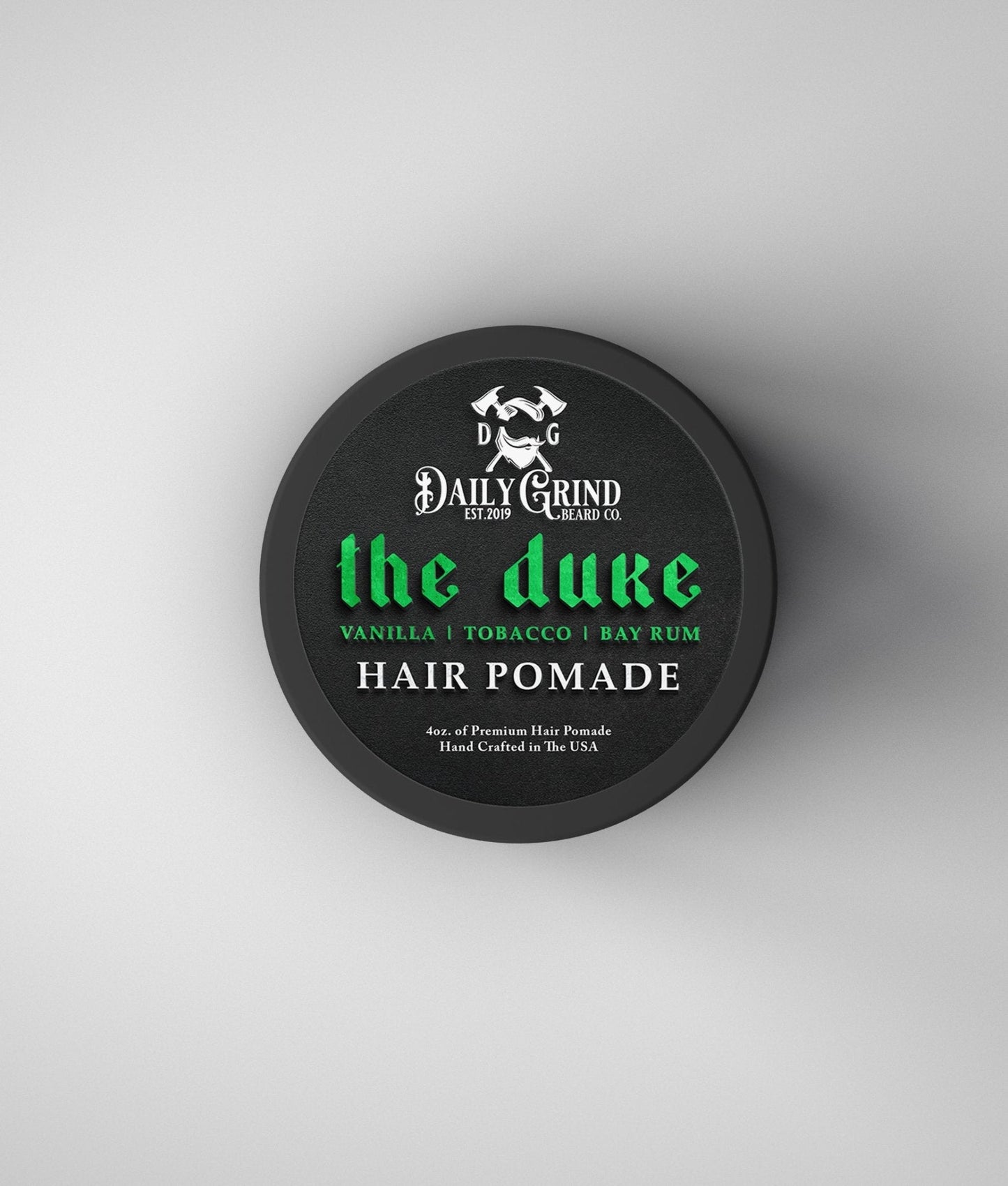 Hair pomade container labeled 'the duke' by Daily Grind on a white background