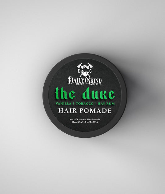 Hair pomade container labeled 'the duke' by Daily Grind on a white background